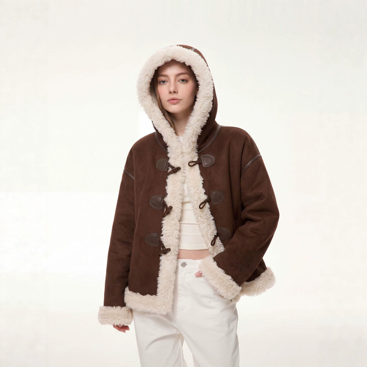 Women’s brown hooded suede shearling jacket, close front view with beige fleece trim