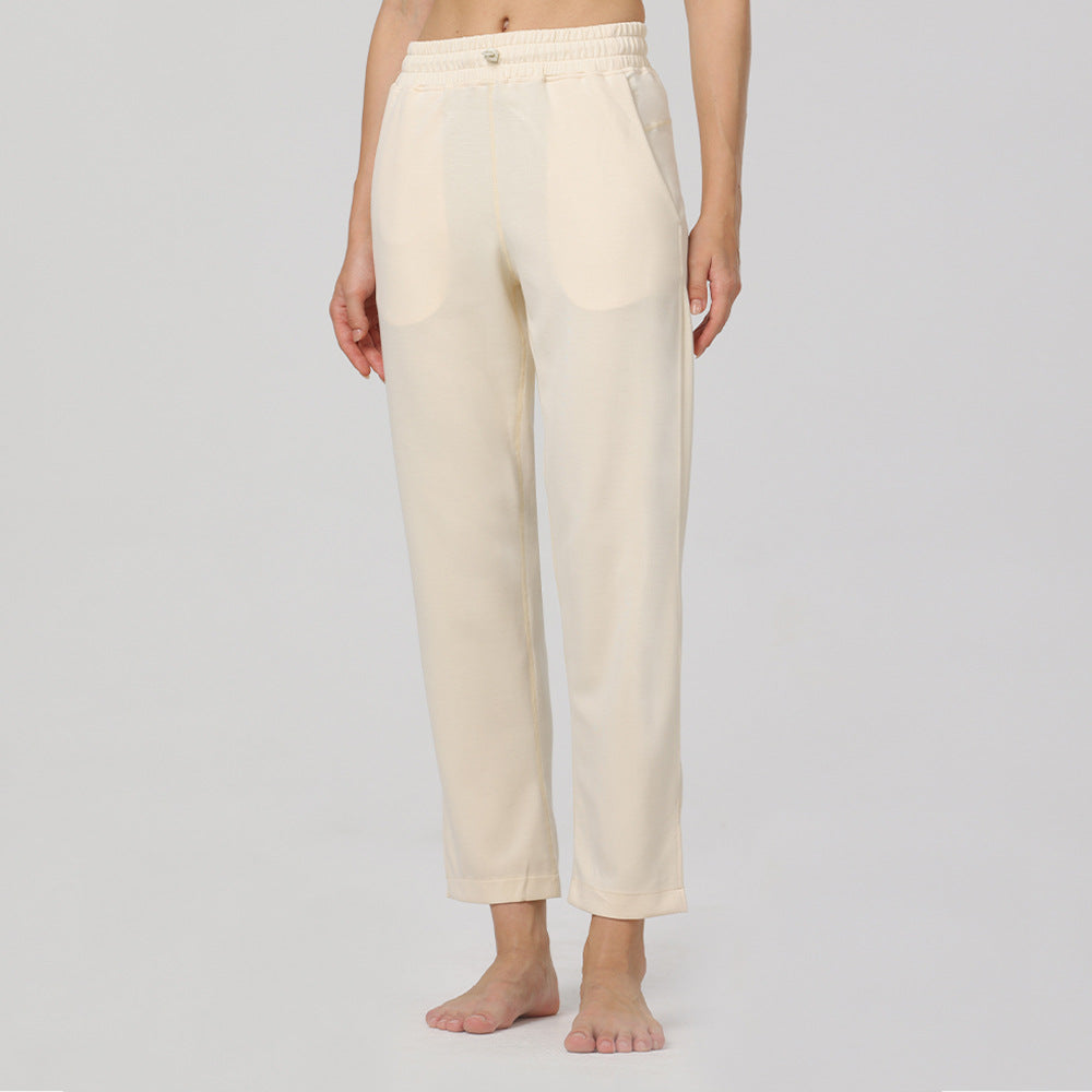 Off-white elastic-waist cotton pants with straight legs and ankle-length hems