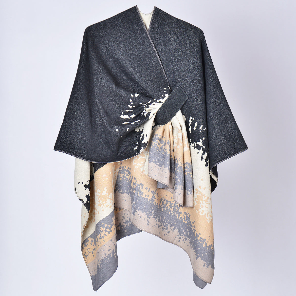 Faux cashmere print shawl, dark gray top with beige and black splash pattern, draped.