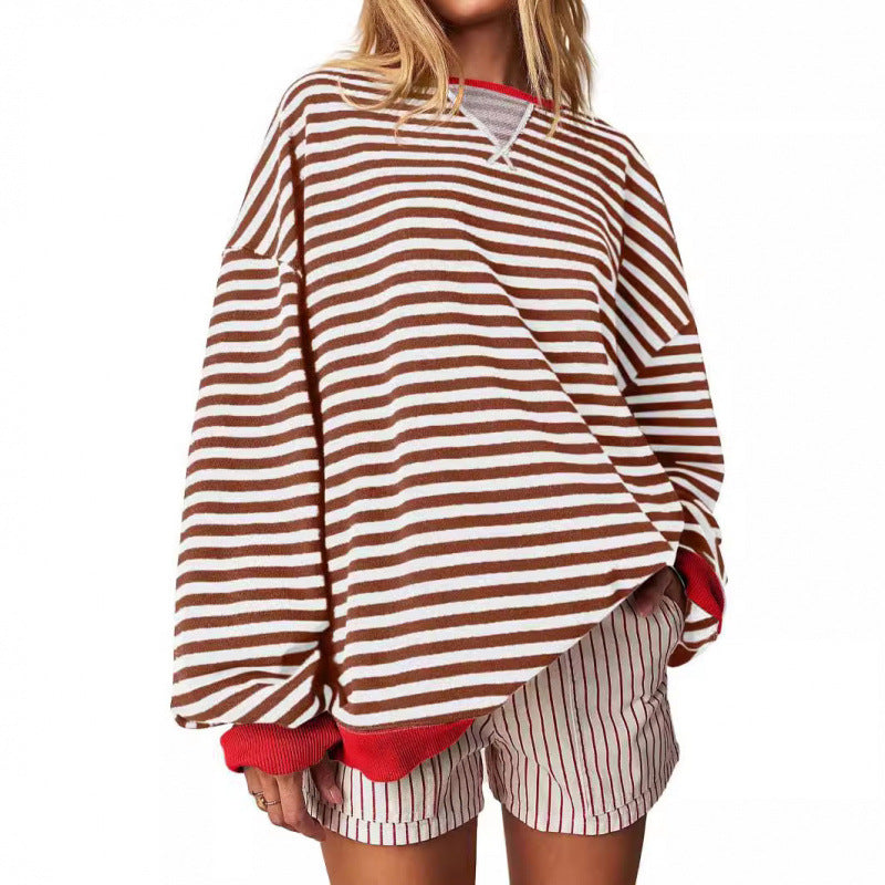 Women’s striped pullover sweatshirt with long sleeves and round neckline, rust and white.