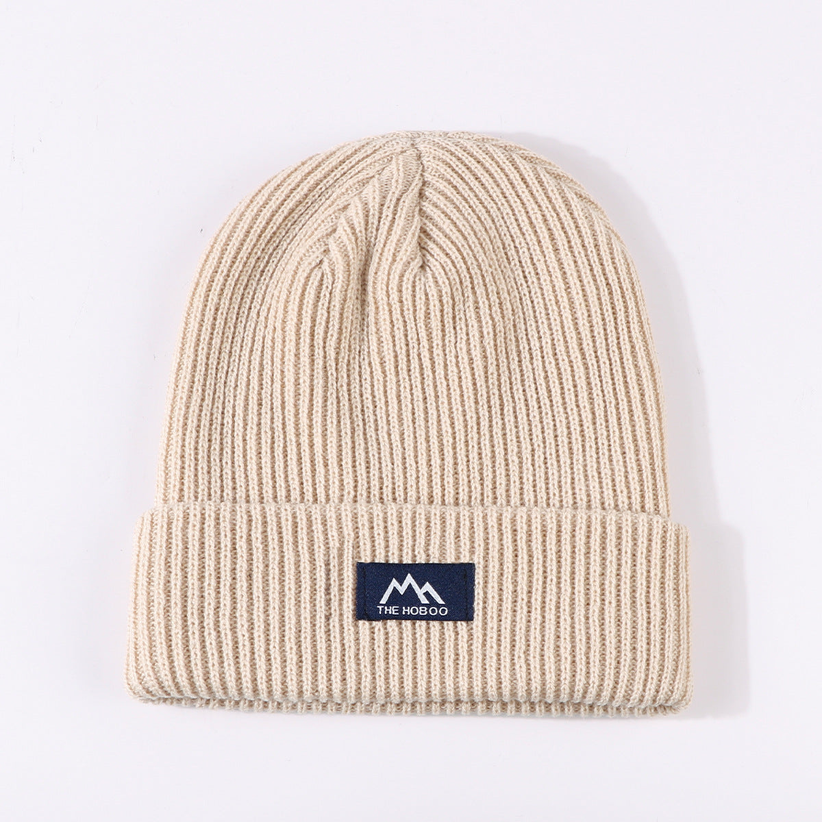 Beige ribbed knit beanie with fold-up cuff and THE HOBOO logo patch
