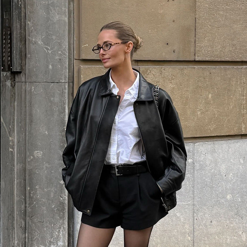 Black matte leather jacket with lapel collar and zip front, long sleeves, relaxed fit