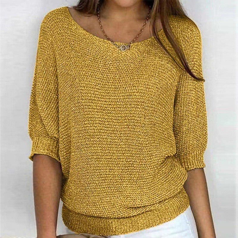 Gold/yellow textured knit top with round neck and three-quarter sleeves, ribbed hem