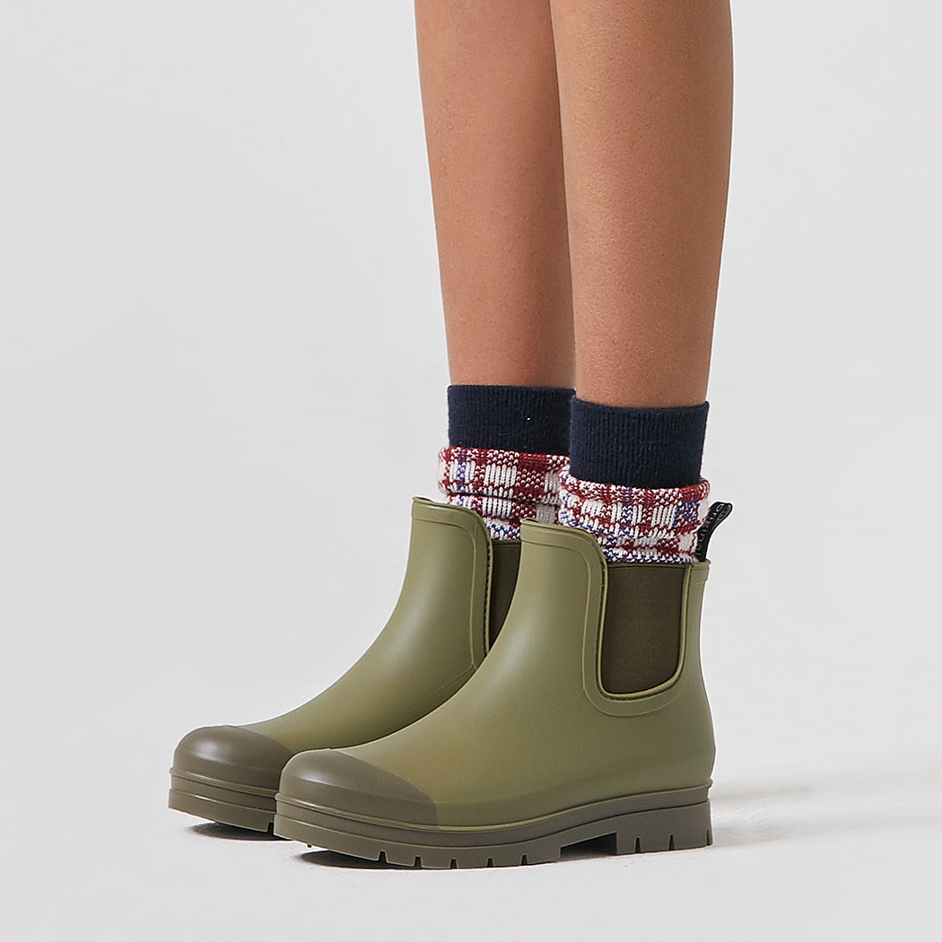 Olive green short rain boots with pull-on side panels and rugged tread outsole