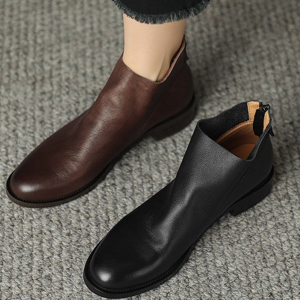 Women’s black short ankle boots with side zipper and chunky sole.
