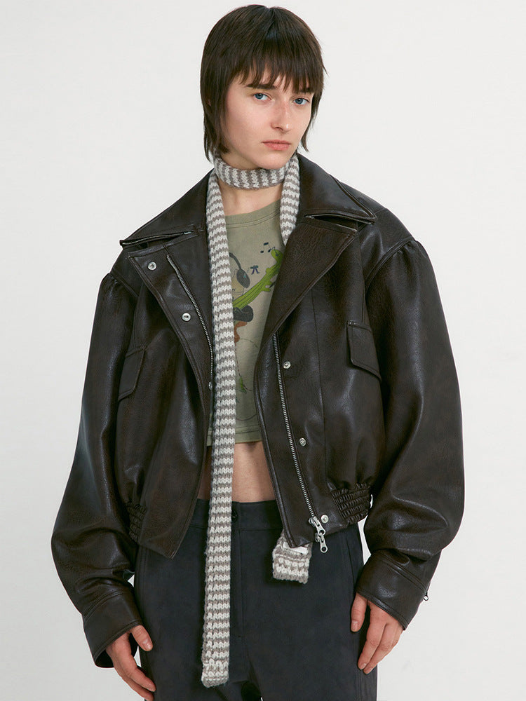 Women's black leather motorcycle jacket with snap buttons, zip front, knit scarf