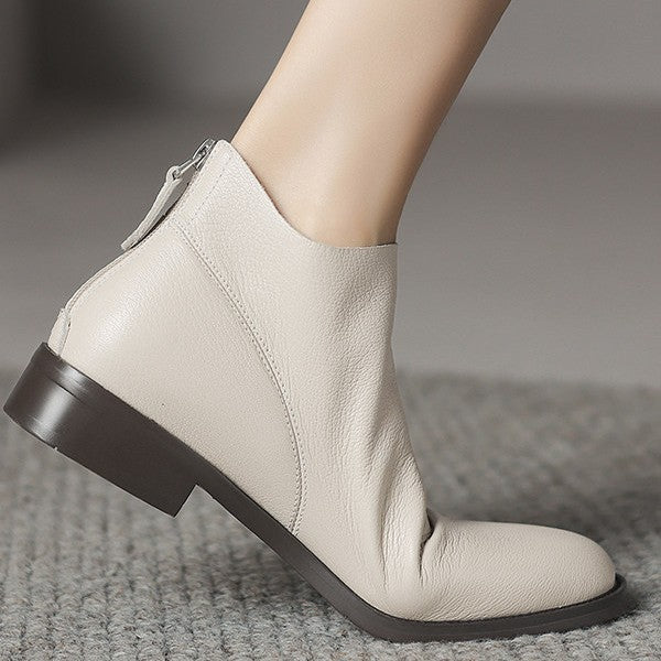 Women’s off-white short ankle boots with chunky heel and side zipper.
