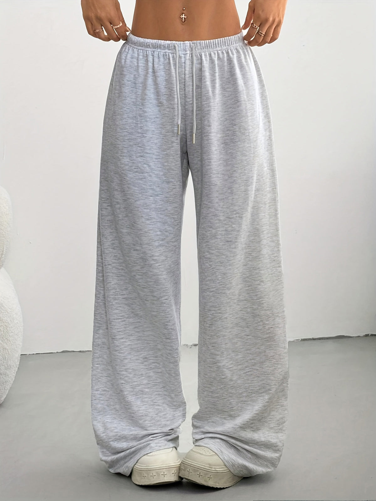 Women's high-waisted wide-leg sweatpants in light gray, loose fit with drawstring.