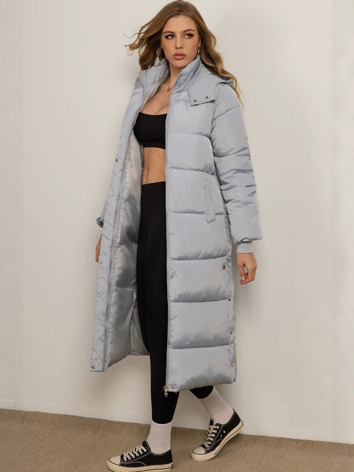 Women's light-blue long padded coat with hood, button front and side pockets