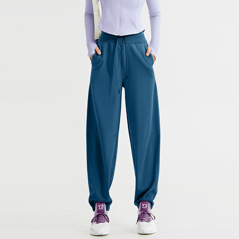 Women's deep teal jogger sweatpants with a drawstring waist, side pockets, and cuffed ankles