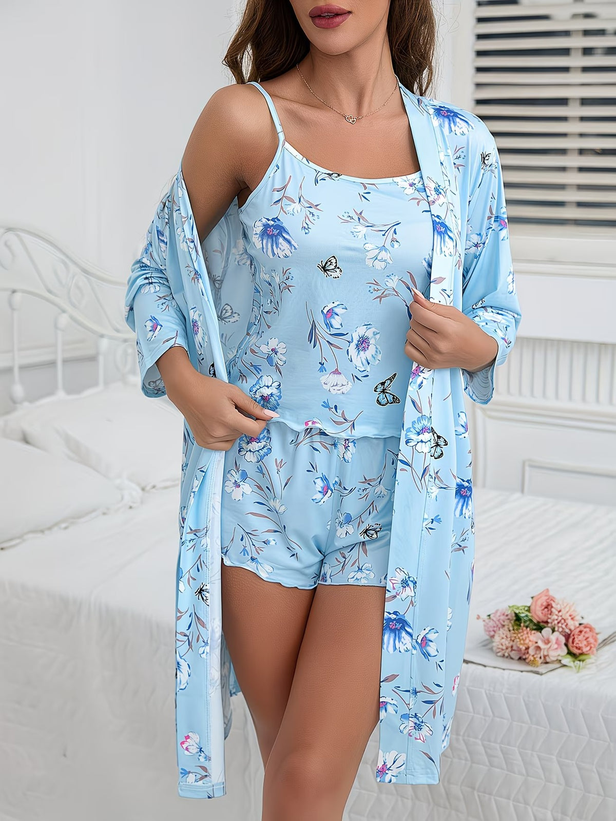 Light blue floral pajama set with thin-strap romper, shorts, and open robe
