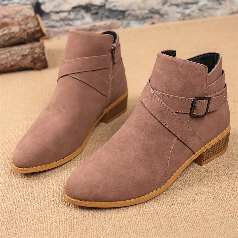 Dusty pink Chelsea ankle boots with side zipper, buckle strap, and block heel.