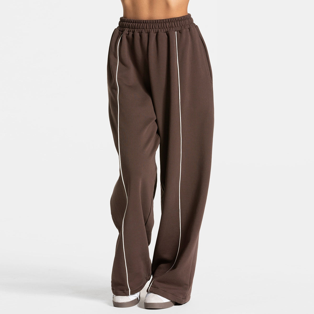 Dark brown loose yoga pants with elastic waistband and vertical white contrast stripe