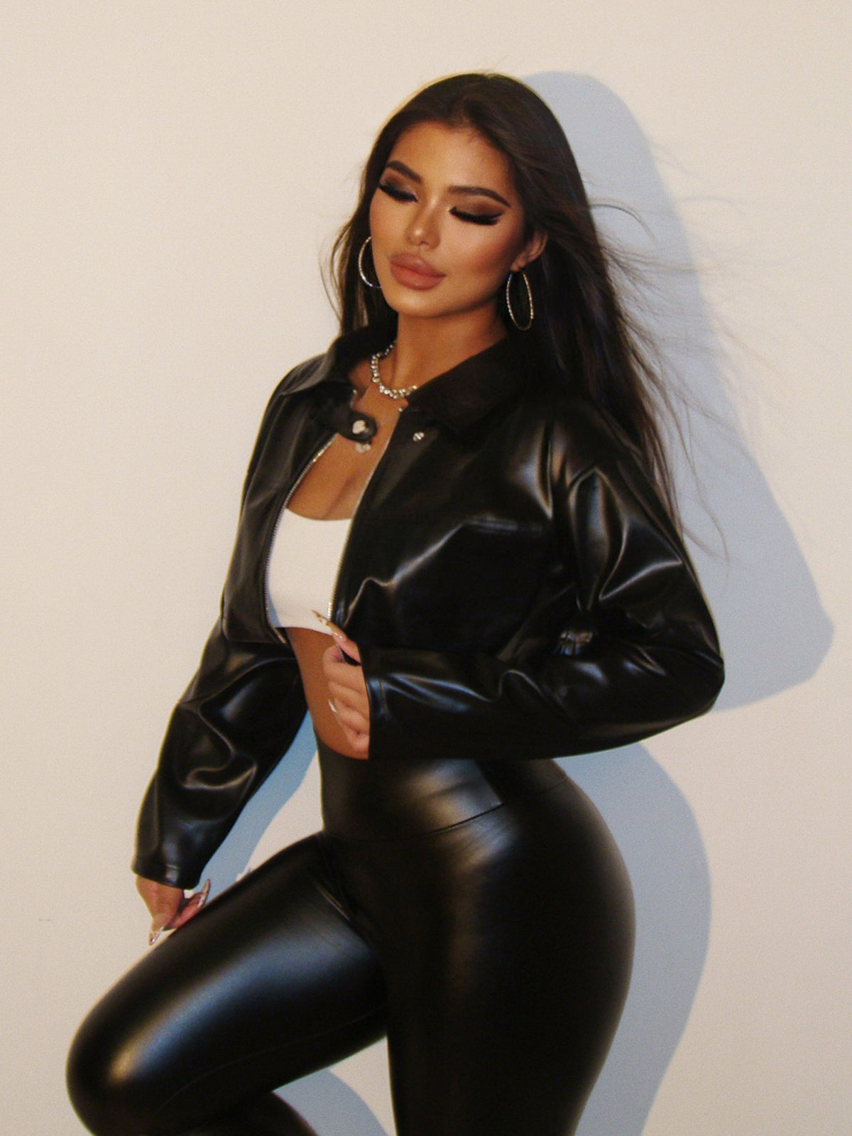 Black cropped faux-leather moto jacket, zip front, stand collar, long sleeves