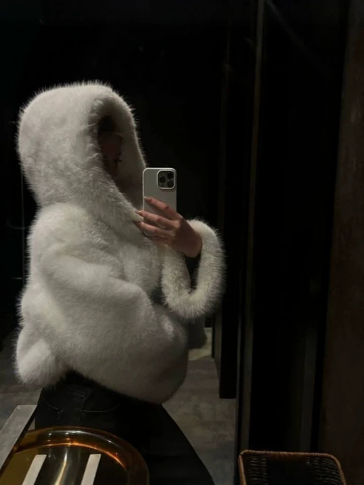 White fluffy hooded faux fur coat, close-up of sleeve and hood