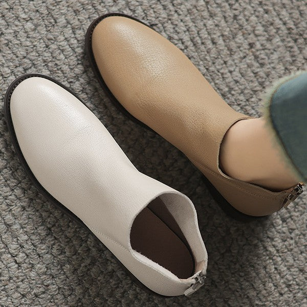 Women’s off-white short boots with open collar and dark outsole detail.