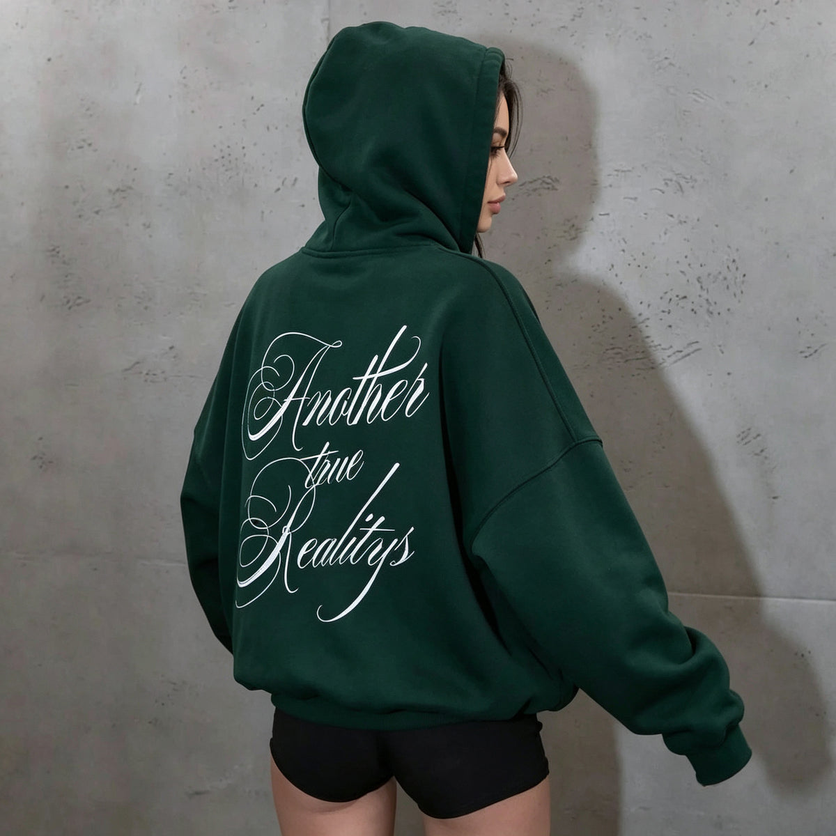 Dark green hooded women's sweatshirt with white back lettering and long sleeves