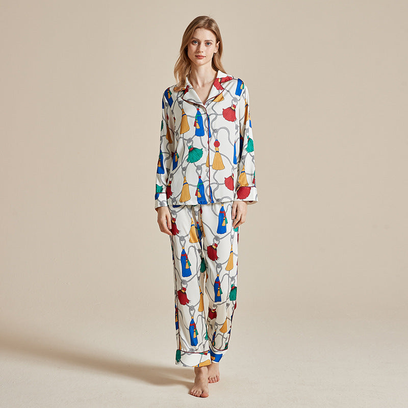 Women’s long-sleeve printed pajama set with colorful circus-style motifs on white