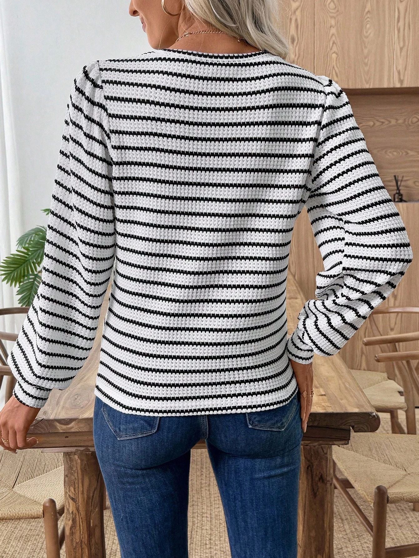 Back view of women’s striped waffle knit crewneck top, black-and-white long sleeves