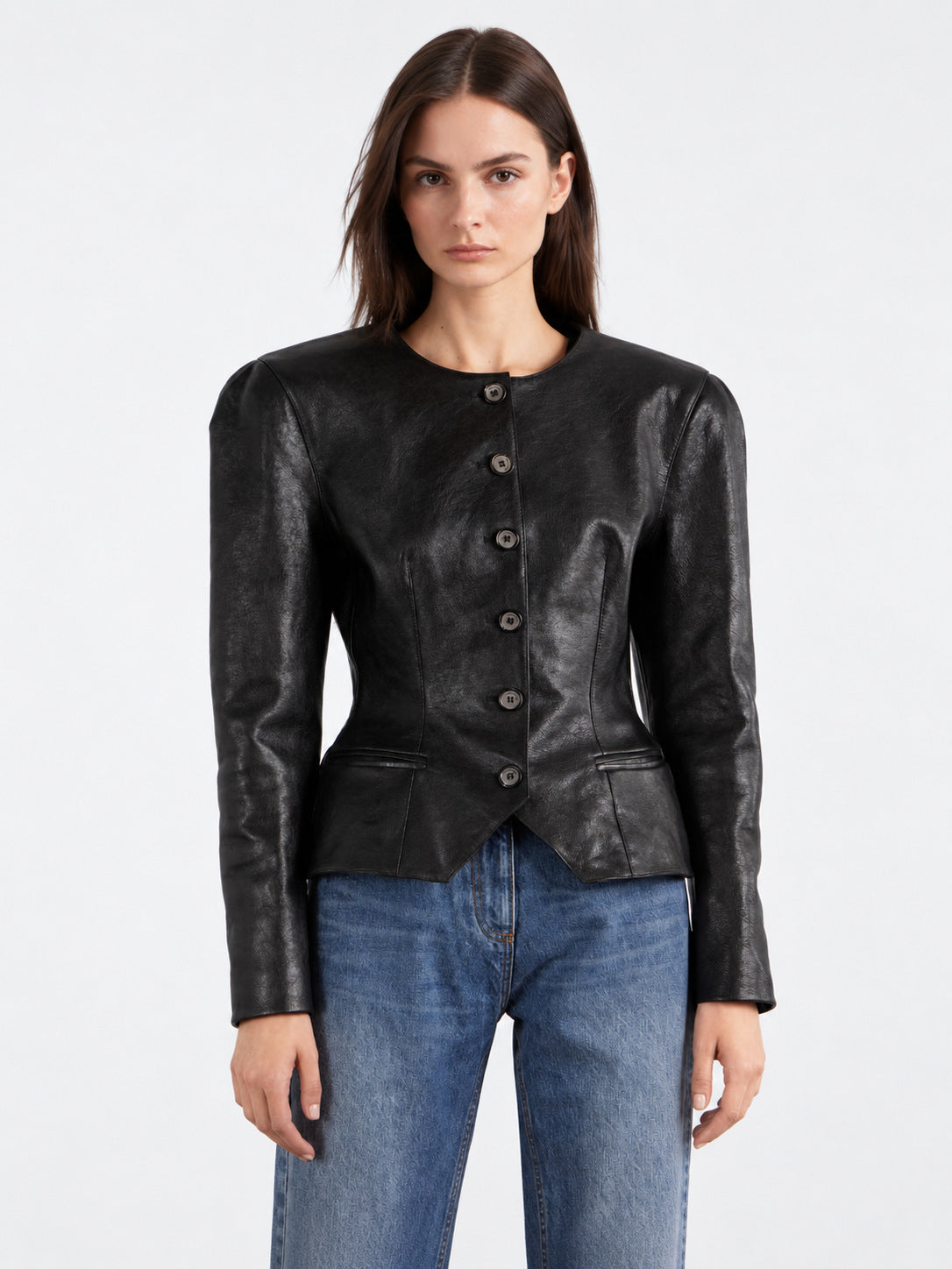Women’s black leather jacket with round neck, button placket, and peplum silhouette.