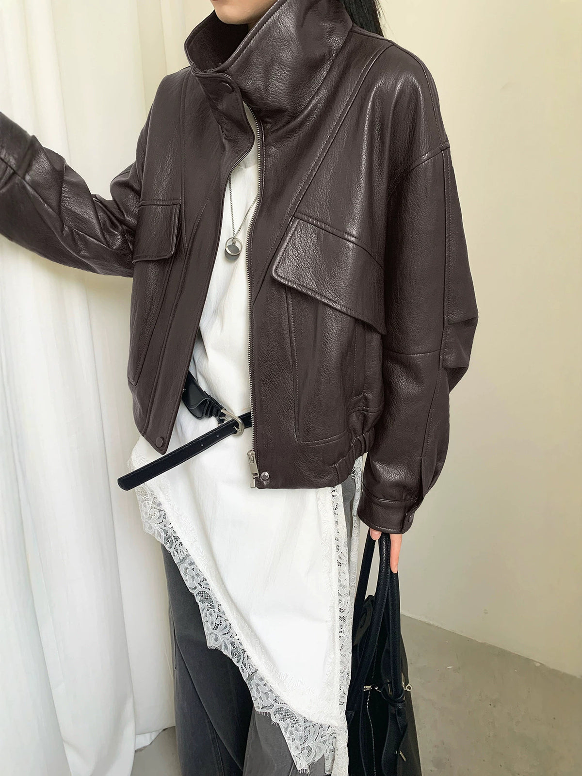 Dark PU leather jacket with stand collar, diagonal zip, front flap pockets
