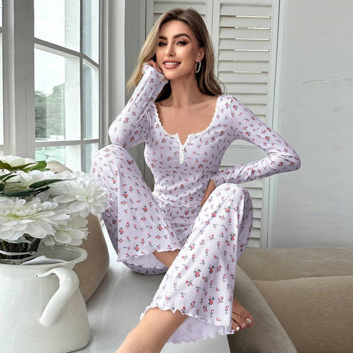 Women’s white floral pajama set with long sleeves, button front, and matching long pants