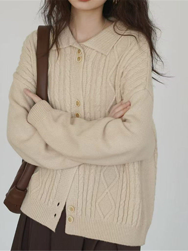 Beige cable-knit cardigan with pointed collar and buttons, shown in a close front view
