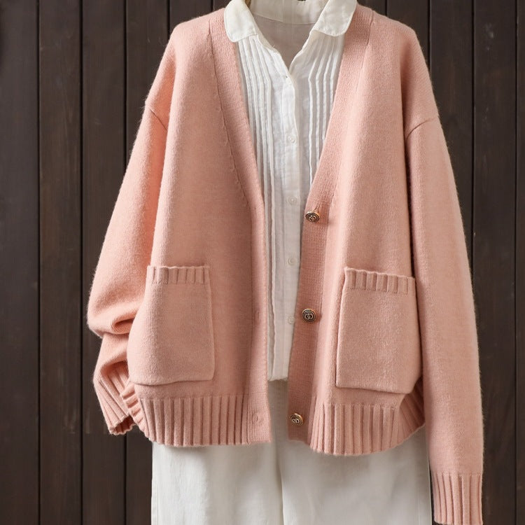 Pink wool cardigan with V-neck and button front, ribbed hem and patch pockets