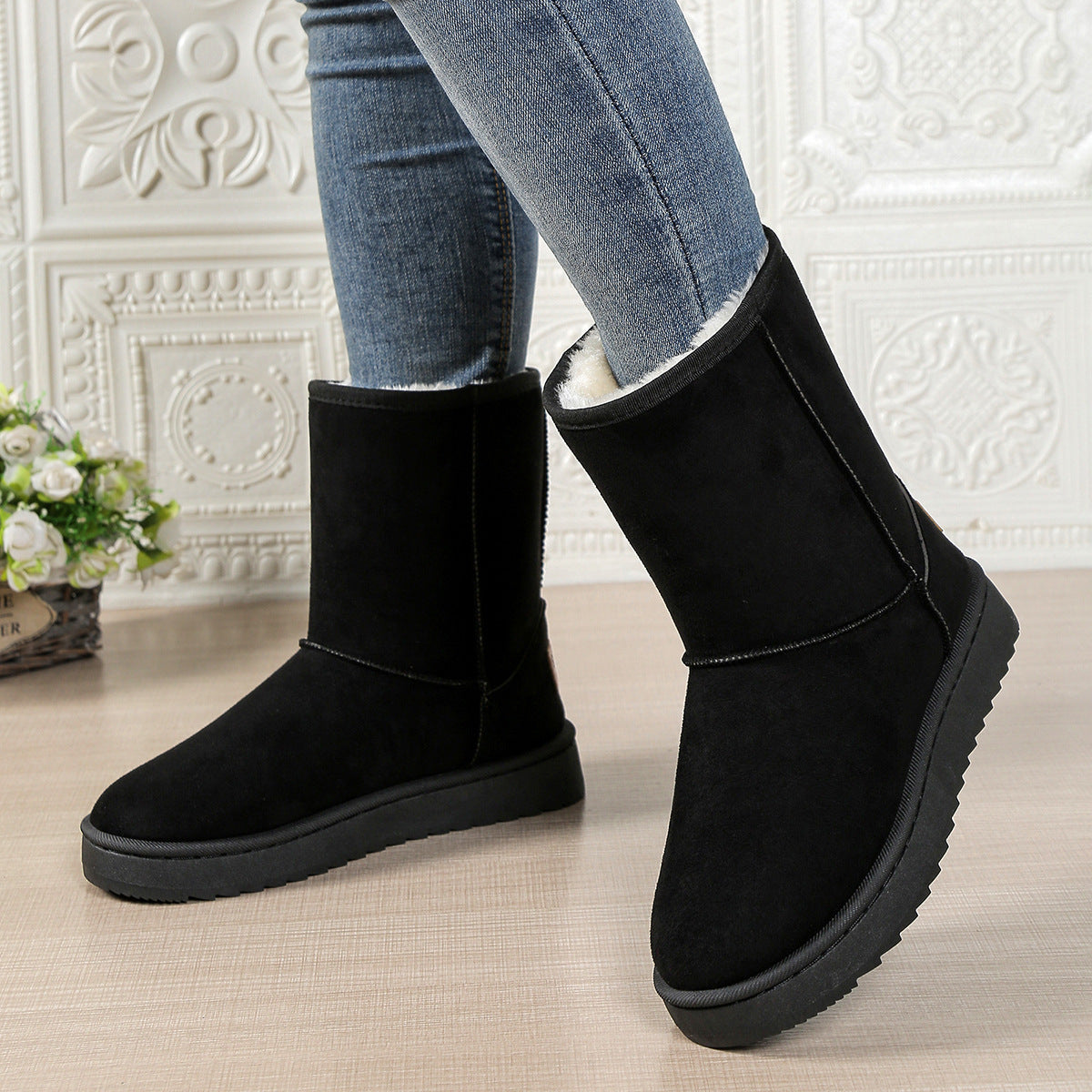Women’s mid-calf fleece-lined slip-on snow boots in black suede with flat rubber sole