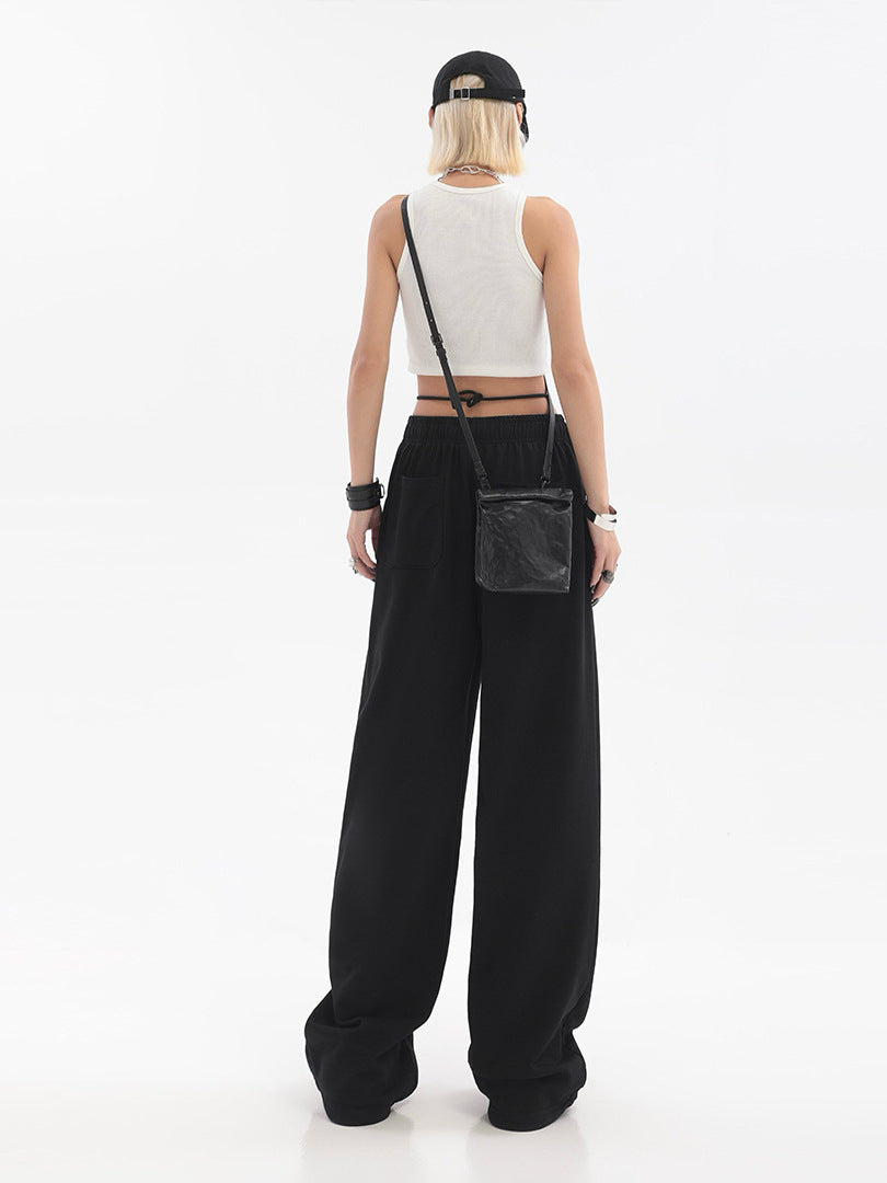 Black high-waist wide-leg fleece-lined pants with elastic waist, shown from the back