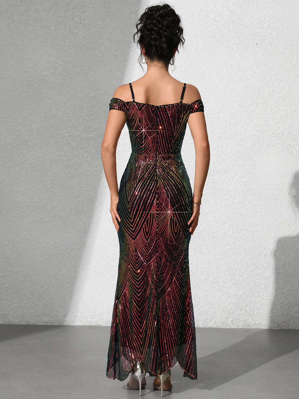 Back view of off-shoulder sequin fishtail dress, burgundy-red patterned fabric and long hem
