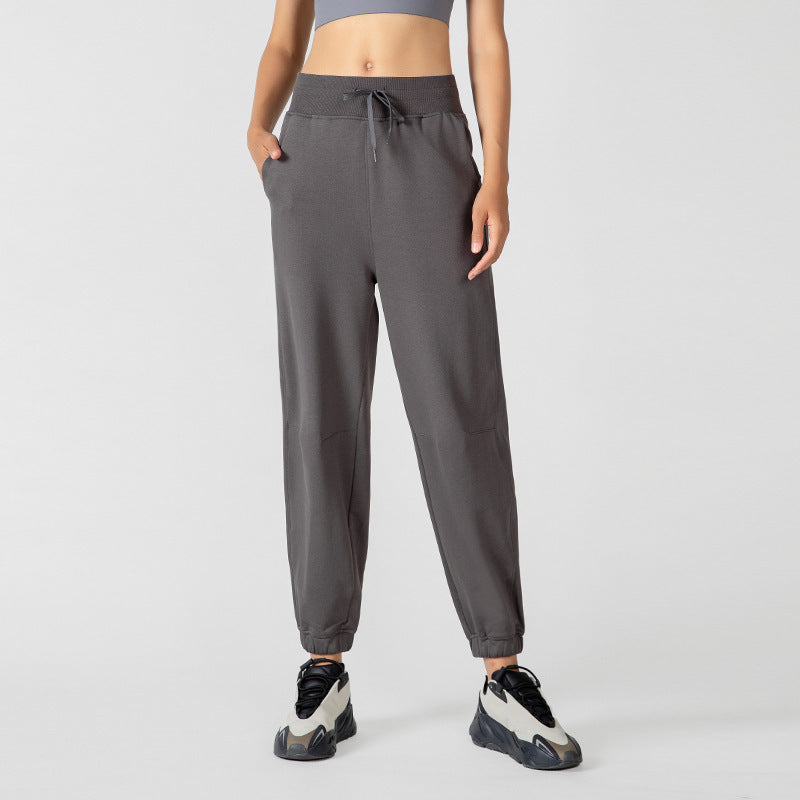 Women's high-waisted dark gray jogger sweatpants with a drawstring waist and side pockets