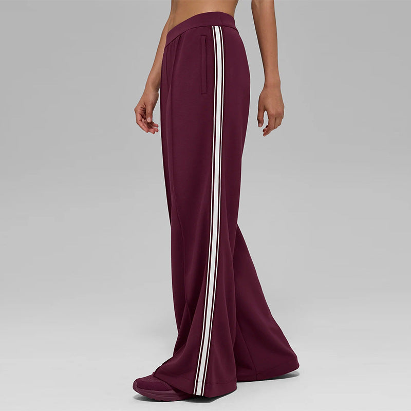 Wine red flared wide-leg pants with tall white side stripe and elastic waist