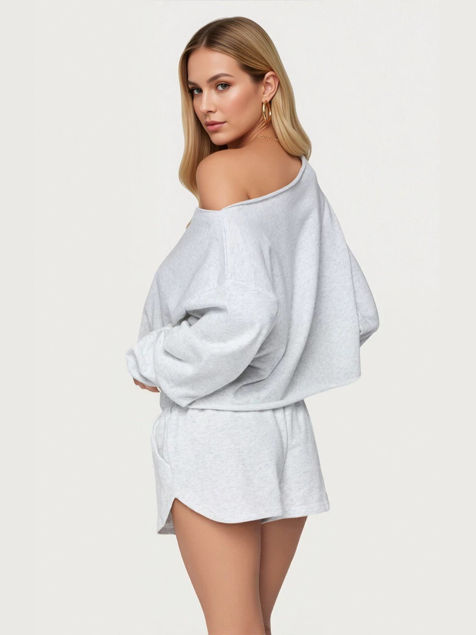 Light gray off-shoulder hoodie with loose sleeves and matching drawstring shorts