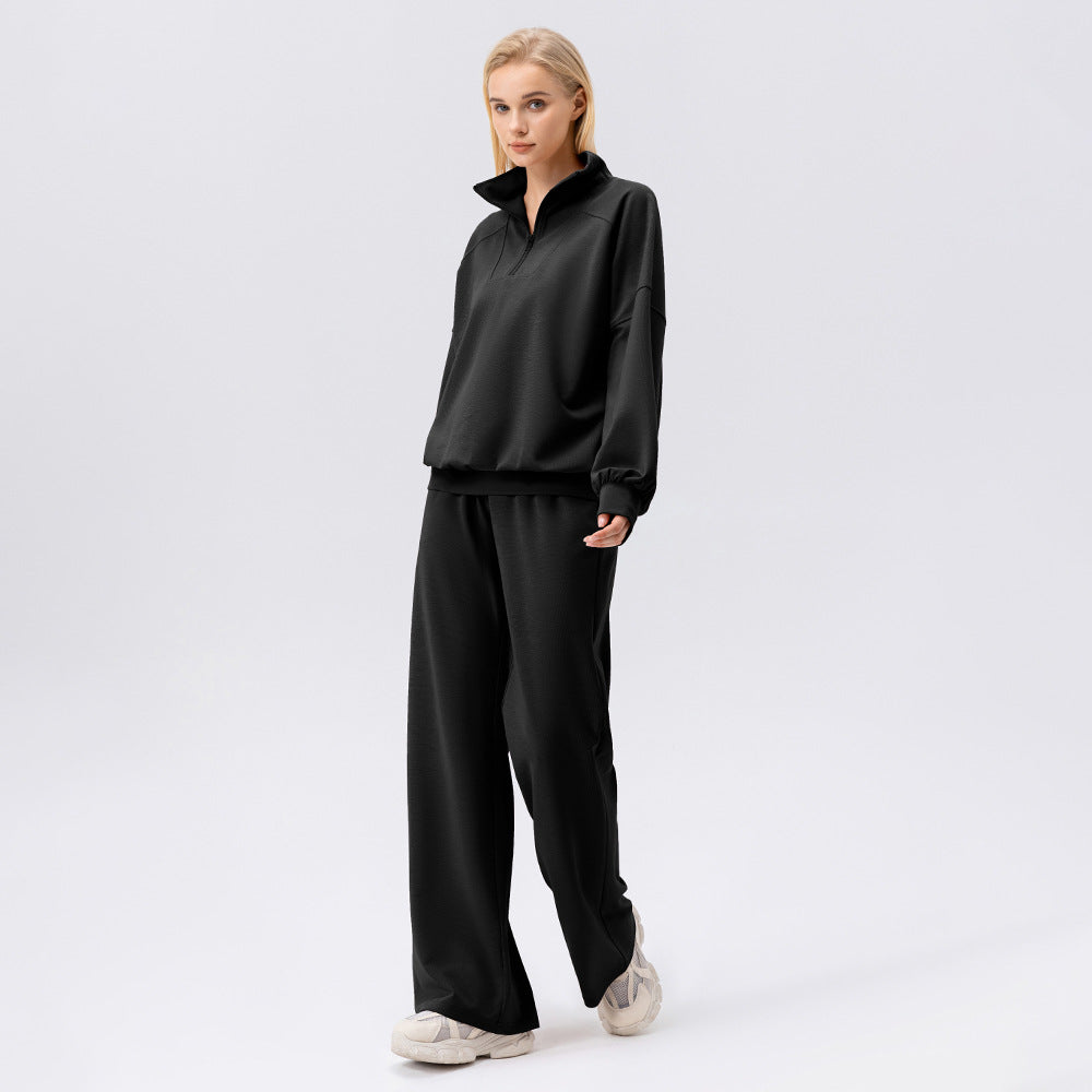 Women’s black quarter-zip style sweatshirt with wide-leg pants, two-piece set
