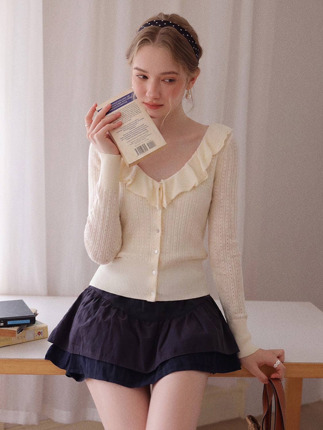 Off-white long-sleeve knit V-neck button top with ruffled collar