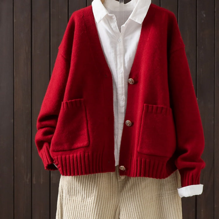 Red wool cardigan with V-neck button front, ribbed hem, and patch pockets