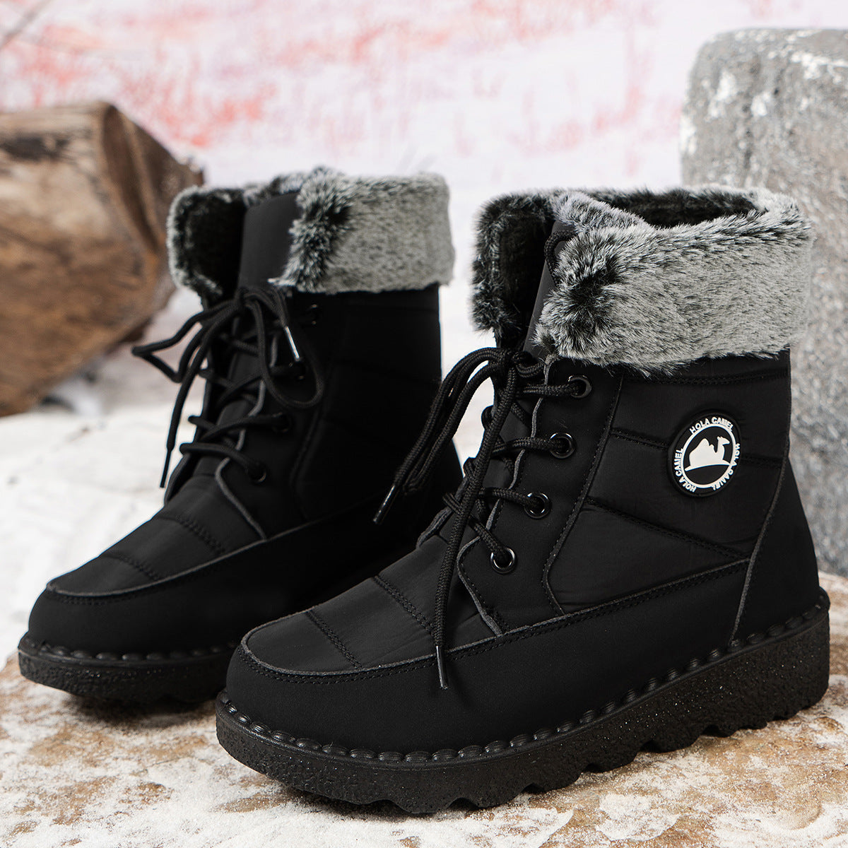 Black lace-up winter boots with faux-fur cuff, side logo patch, and chunky sole