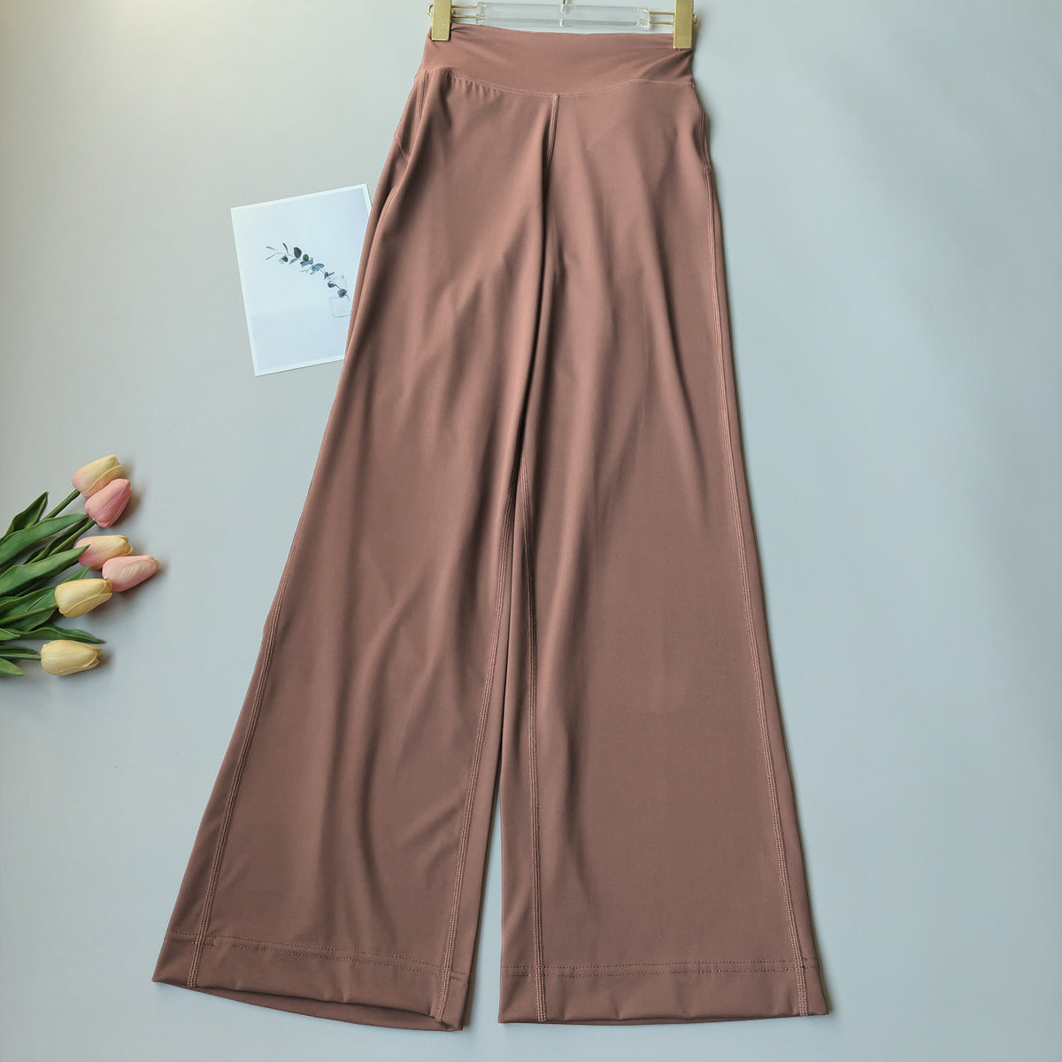 High-waisted brown fitness pants with wide straight-to-flare legs