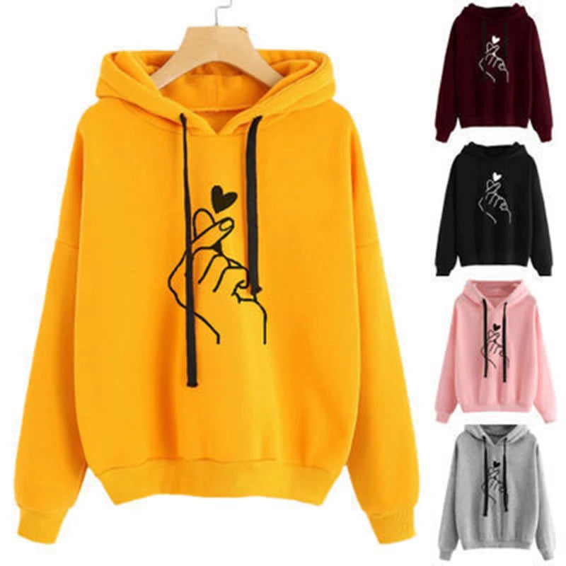 Yellow fleece hoodie with black drawstrings and finger-heart graphic, plus color options