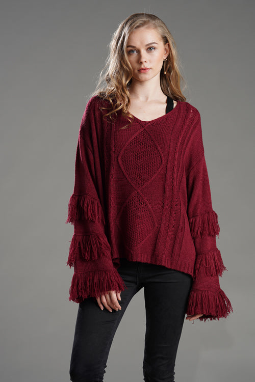 Red tassel knit sweater with diamond yoke and tiered fringe sleeve trim