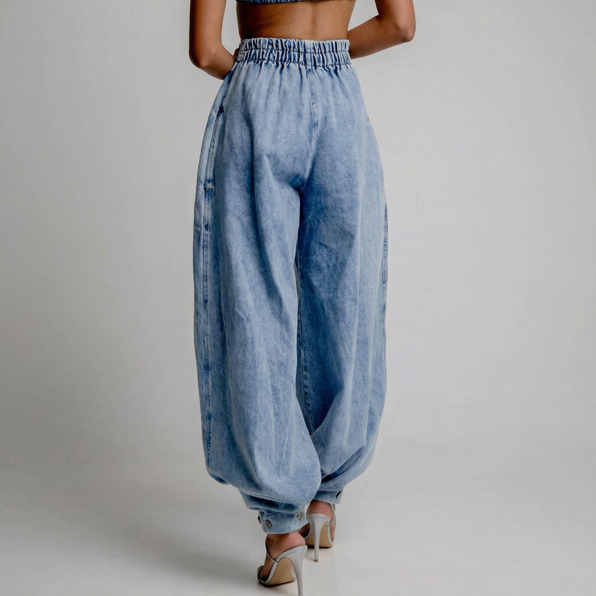 Blue high-waist balloon-leg jeans with elastic back waistband and cuffed hem