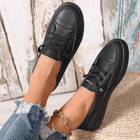 Women’s black chunky platform lace-up sneakers in faux leather, two-shoe side view with laces.