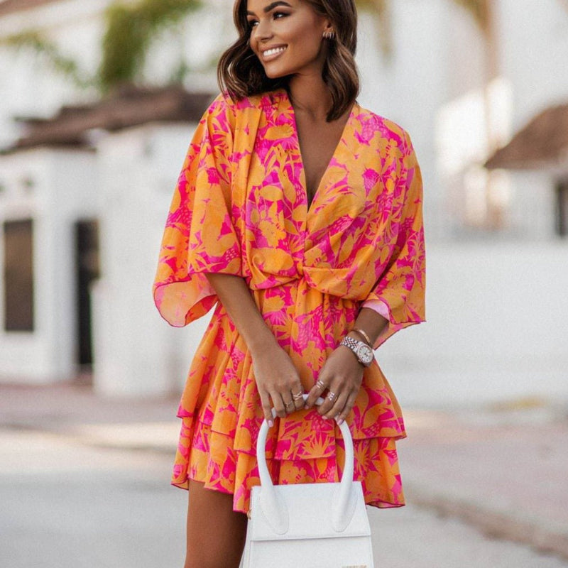 Orange floral chiffon mini dress with V-neck, ruffled waist, tiered skirt, tie belt