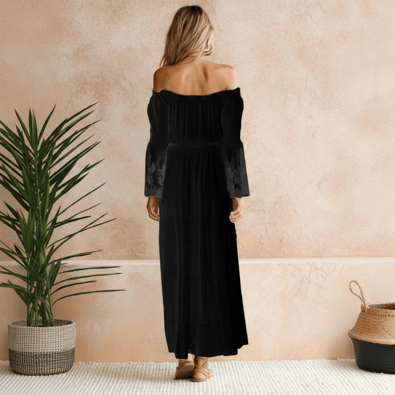 Black off-shoulder cotton maxi dress, back view with tiered skirt and lace sleeves