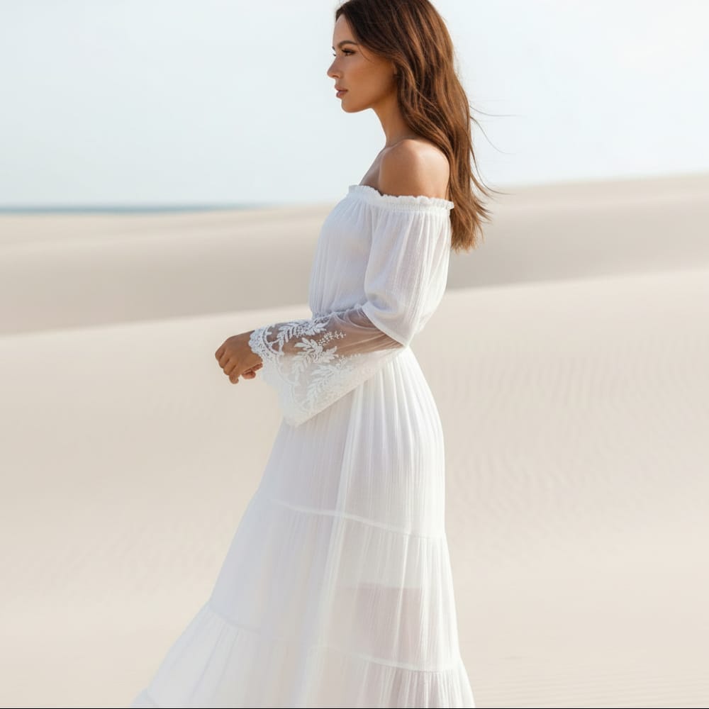 White off-shoulder maxi dress with smocked waist, lace-trim bell sleeves, tiered skirt