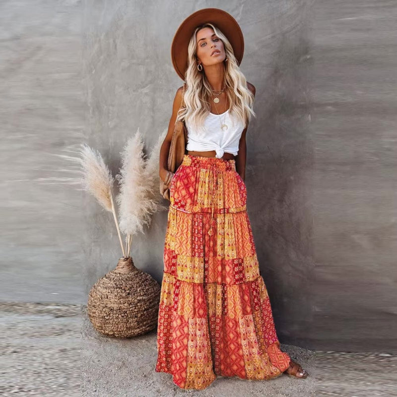 Tiered cotton maxi skirt with patchwork floral print, elastic waist, orange-red
