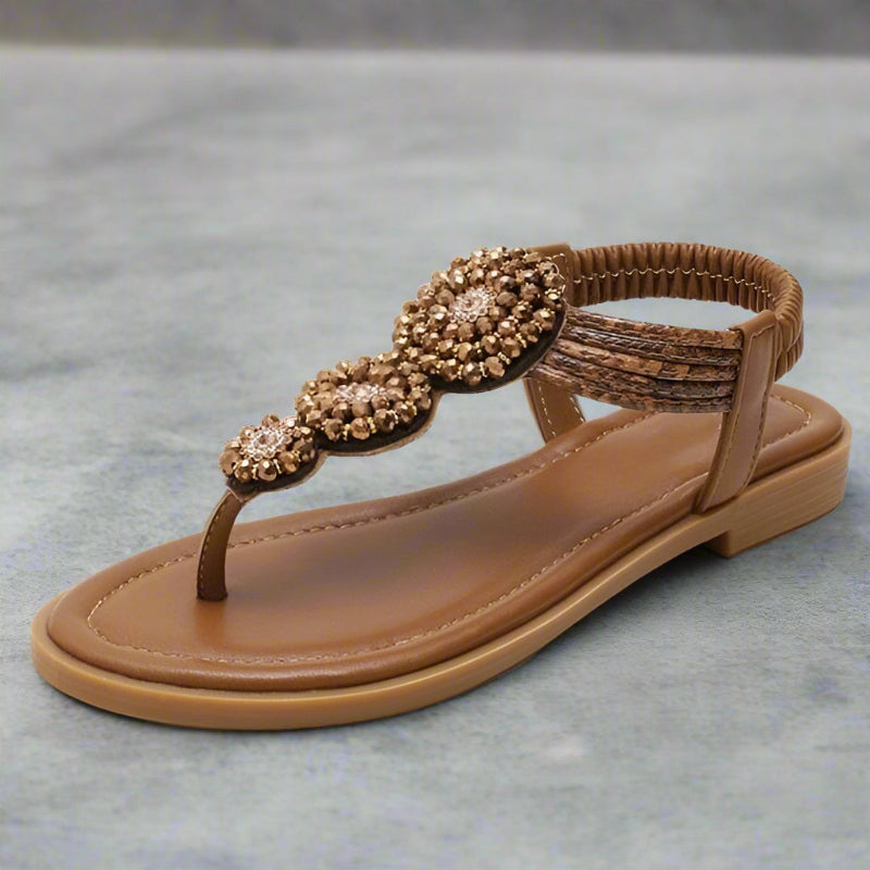 Beige flat thong sandals with gold beaded floral medallion strap and braided top