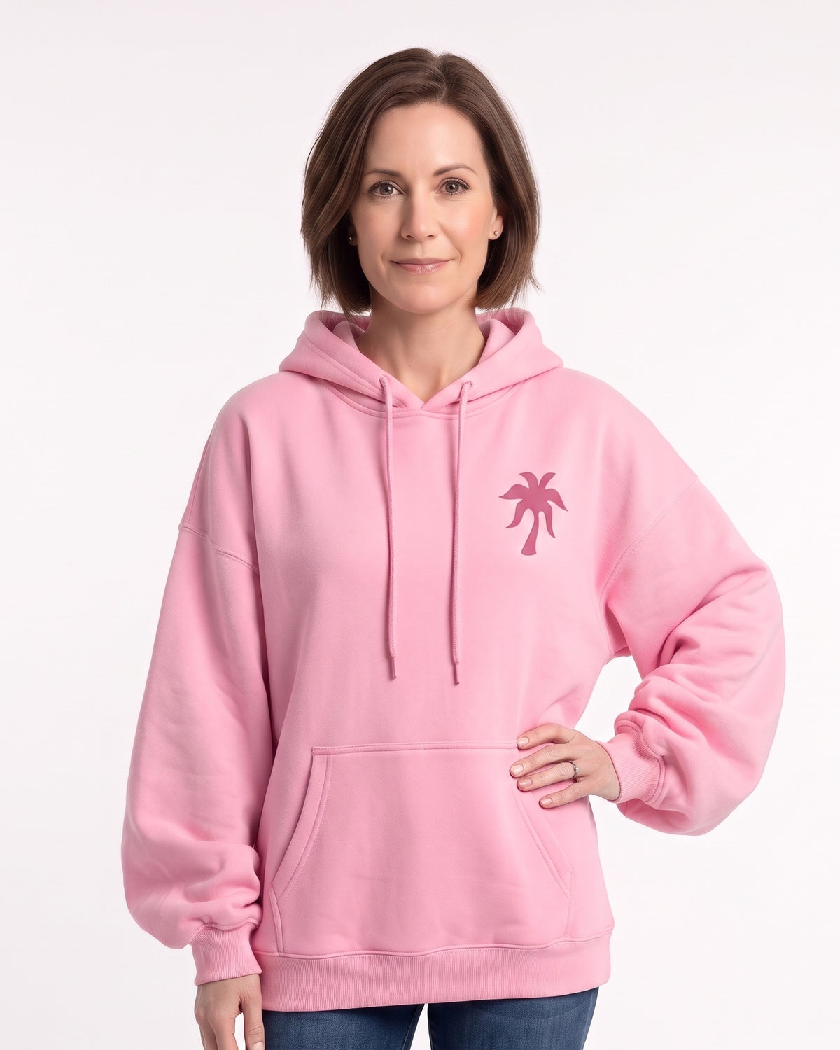 Pink women's hoodie with drawstring hood, front pouch pocket, and small palm tree chest graphic