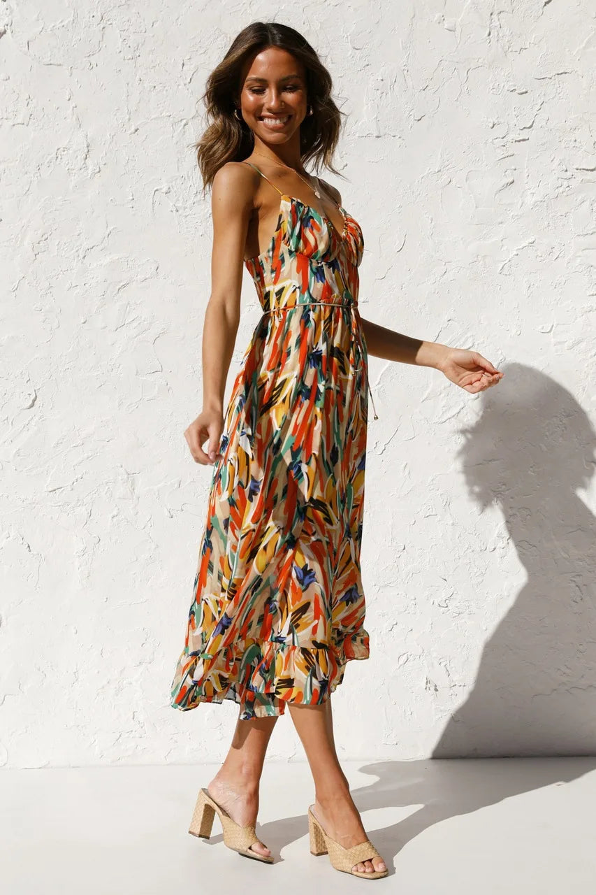 Floral spaghetti strap midi dress in orange multi-color print, cinched waist, flowing tiered hem